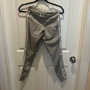 Small Grey Addidas leggings with white stripes.